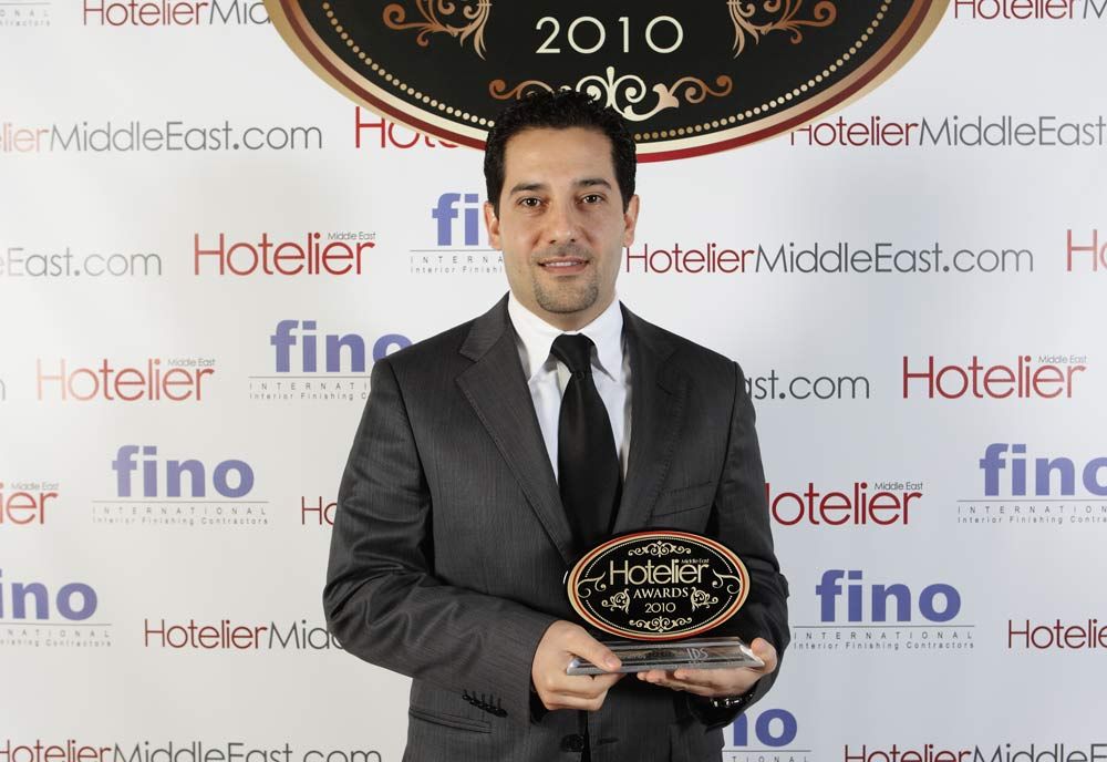 Cam Sourani at the Hotelier Middle East Awards 2010, holding the trophy